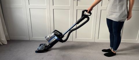 The Shark Anti Hair Wrap Cordless Upright Vacuum Cleaner with PowerFins, Powered Lift-Away & TruePet ICZ300UK being used to vacuum a floor