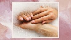 a pink watercolour frame containing an image of a woman's hands with a sheer pink manicure in bubbly water, washing them
