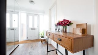 A hallway table with flowers