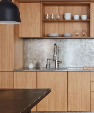 A minimalistic wood paneled kitchen