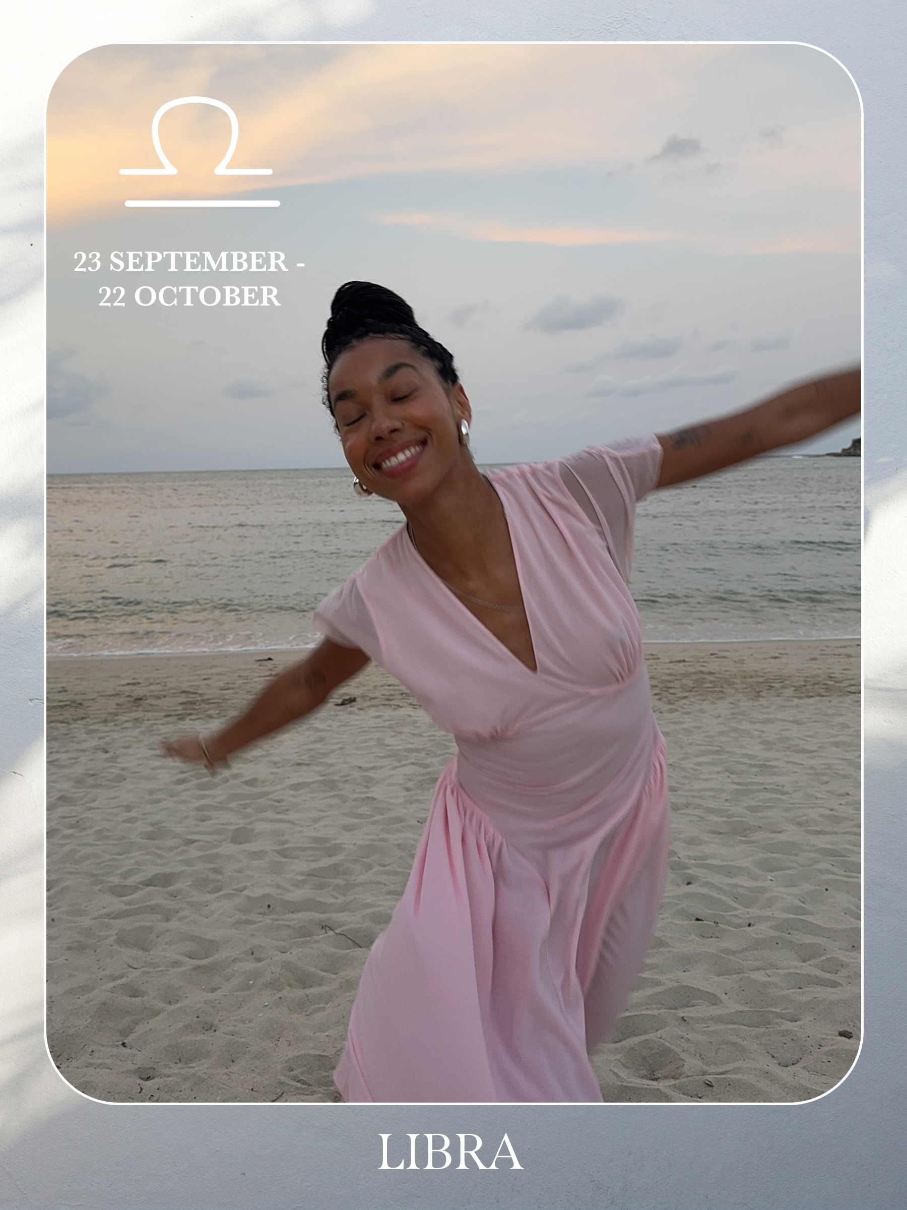 An image of @amaka.hamelijnck posing on a beach wearing a pink maxi dress, showcasing the characteristics of sun sign dressing if you're a Libra.