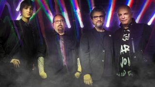 prog band Rain standing together against a display of laser lights