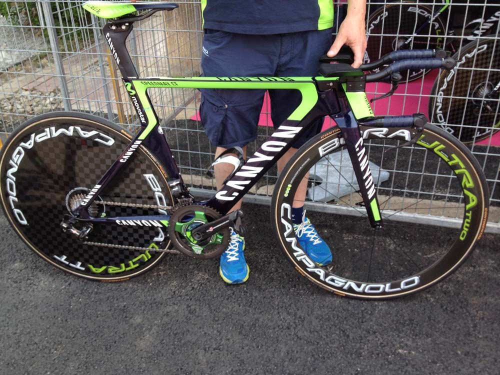 A Movistar mechanic takes a Canyon bike to the UCI judges for dimension approval