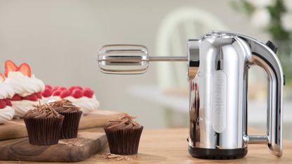Image of Dualit mixer in promotional image with chocolate cupcakes