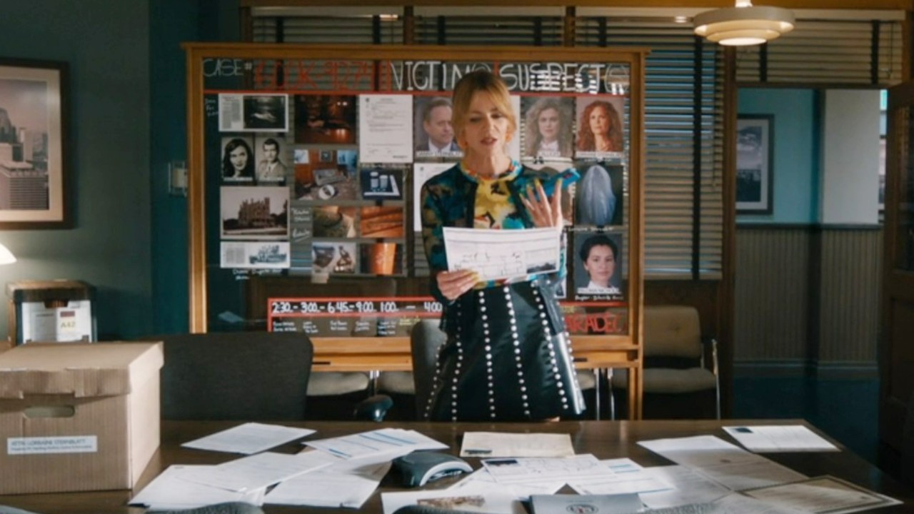 Kaitlin Olson looking at a file in High Potential.