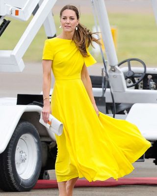 Kate Middleton wearing a yellow short sleeved dress