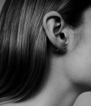 woman wearing earring by Jenny Sweetnam fine jewellery