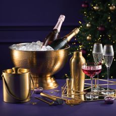 gold champage bowl and ice bucket filled with champagne