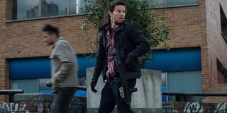 Mile 22 Mark Wahlberg James Silva patrols a block with his weapon