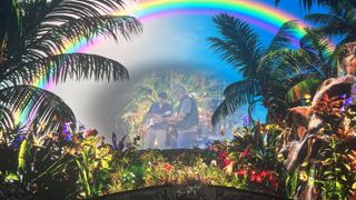 Dead and Company jam out on the Vegas Sphere stage with a rainforest and rainbow behind them.