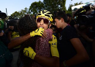 Egan Bernal (Team Ineos) celebrates with his family at the end of the Tour de France