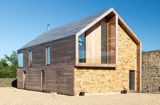 extension with wood and stone cladding photographed by Jennie Webb and Rob Rhodes