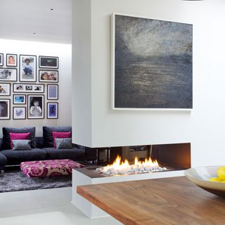 living room with gallery on white wall and fireplace