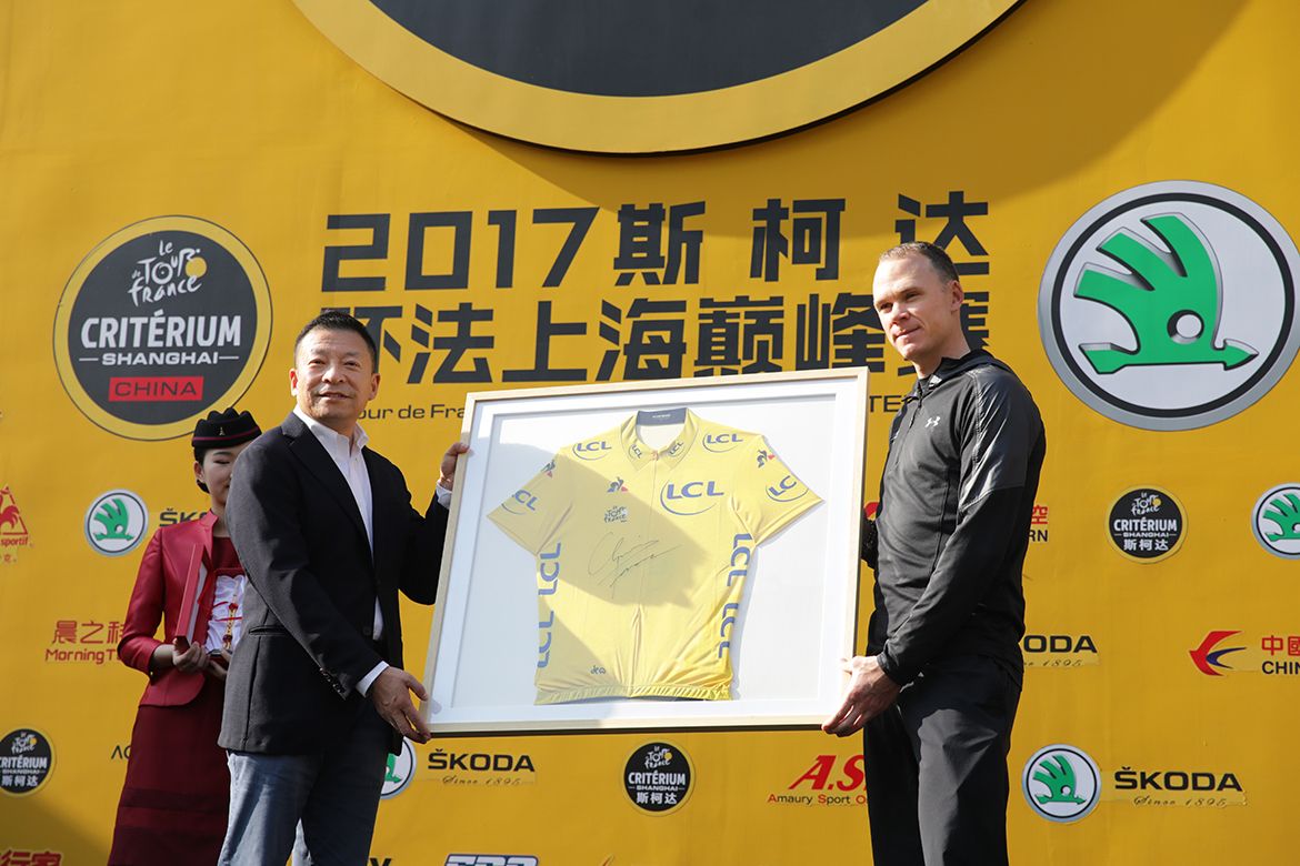 Chris Froome is presented with a framed yellow jersey