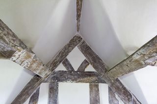 lime plaster shown in eaves of attic with beams
