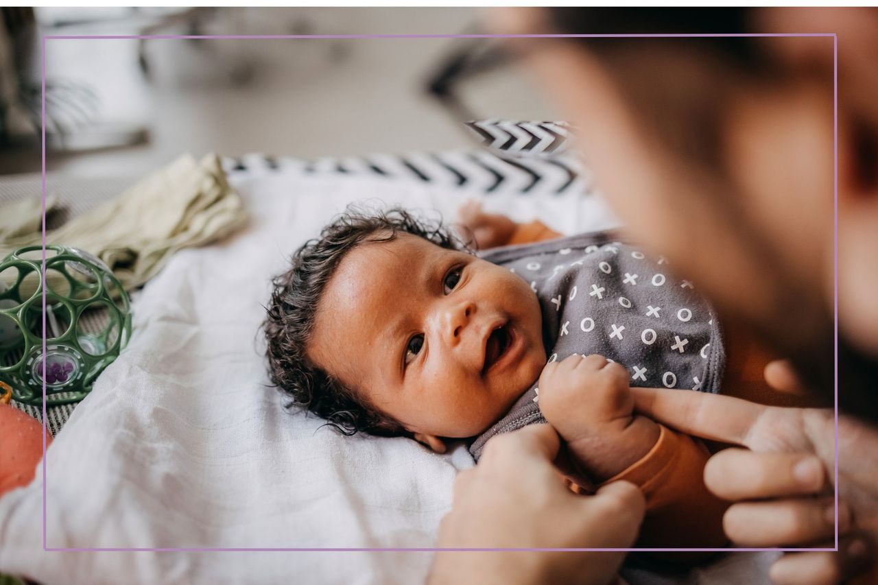 baby grabbing finger of adult