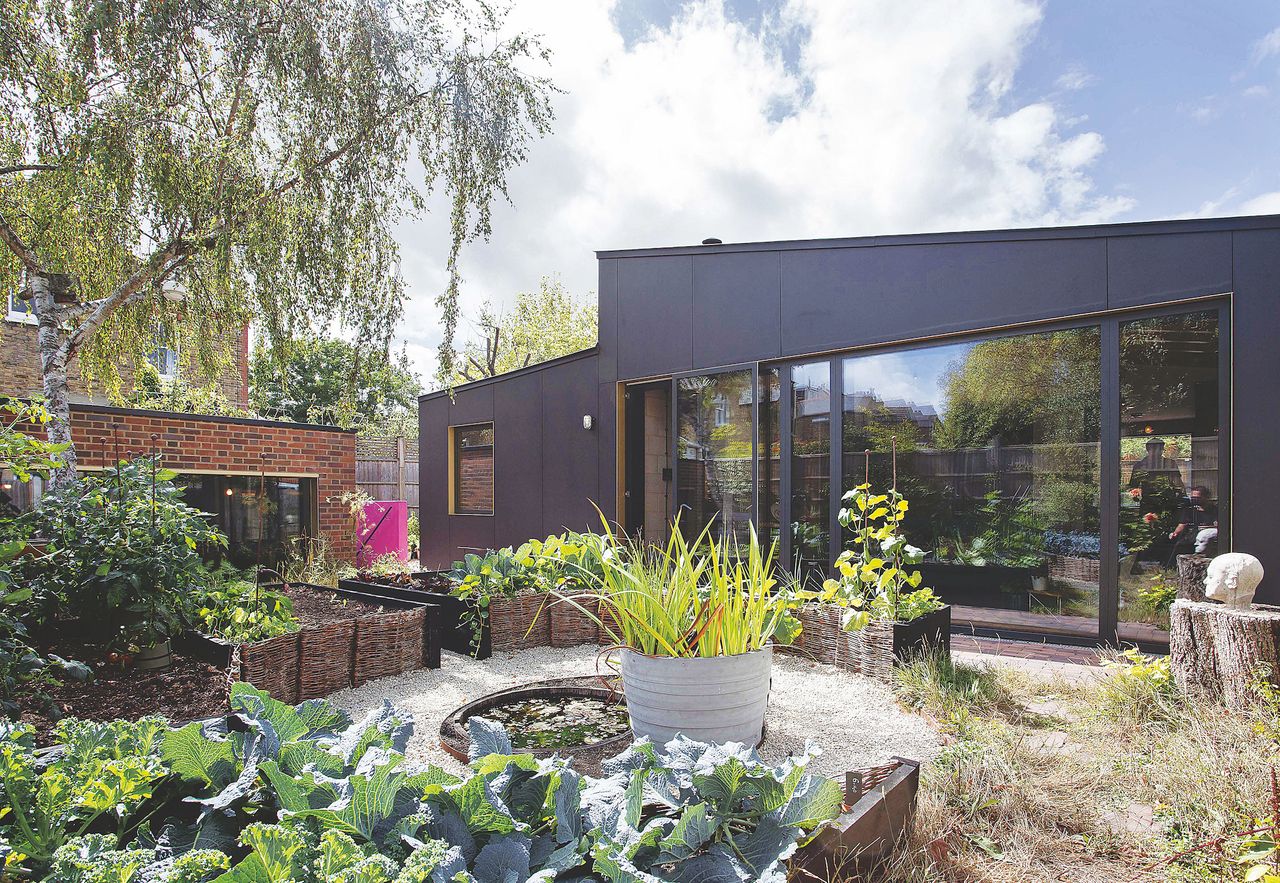 black clad self build with large sliding doors and garden