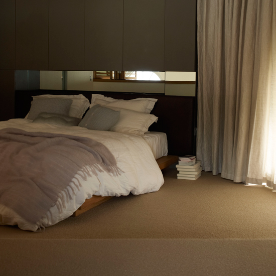 bedroom with curtains and bed with pillows