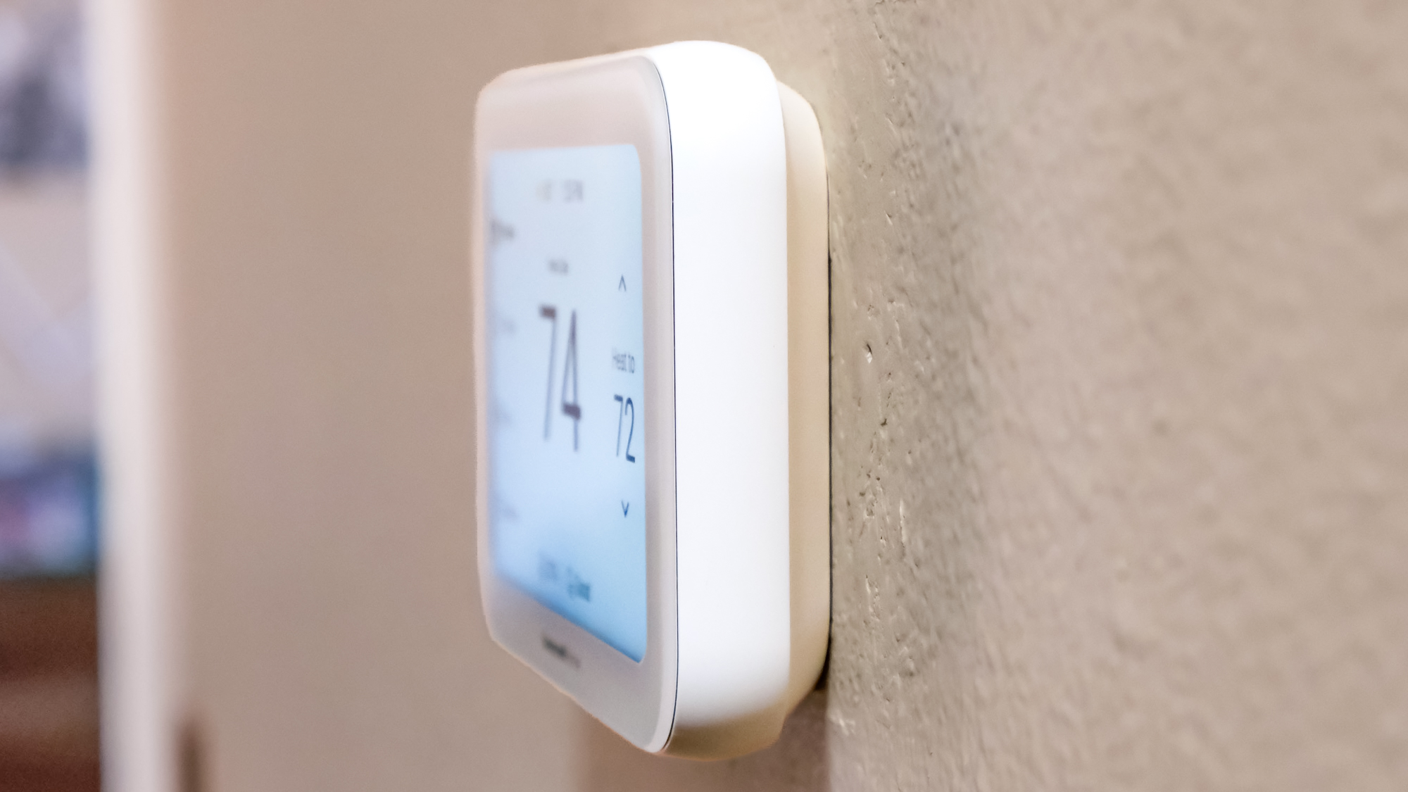 Honeywell Home X8S Smart Thermostat mounted to a hallway wall