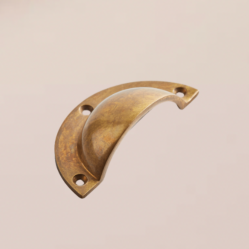 An antique brass pull handle