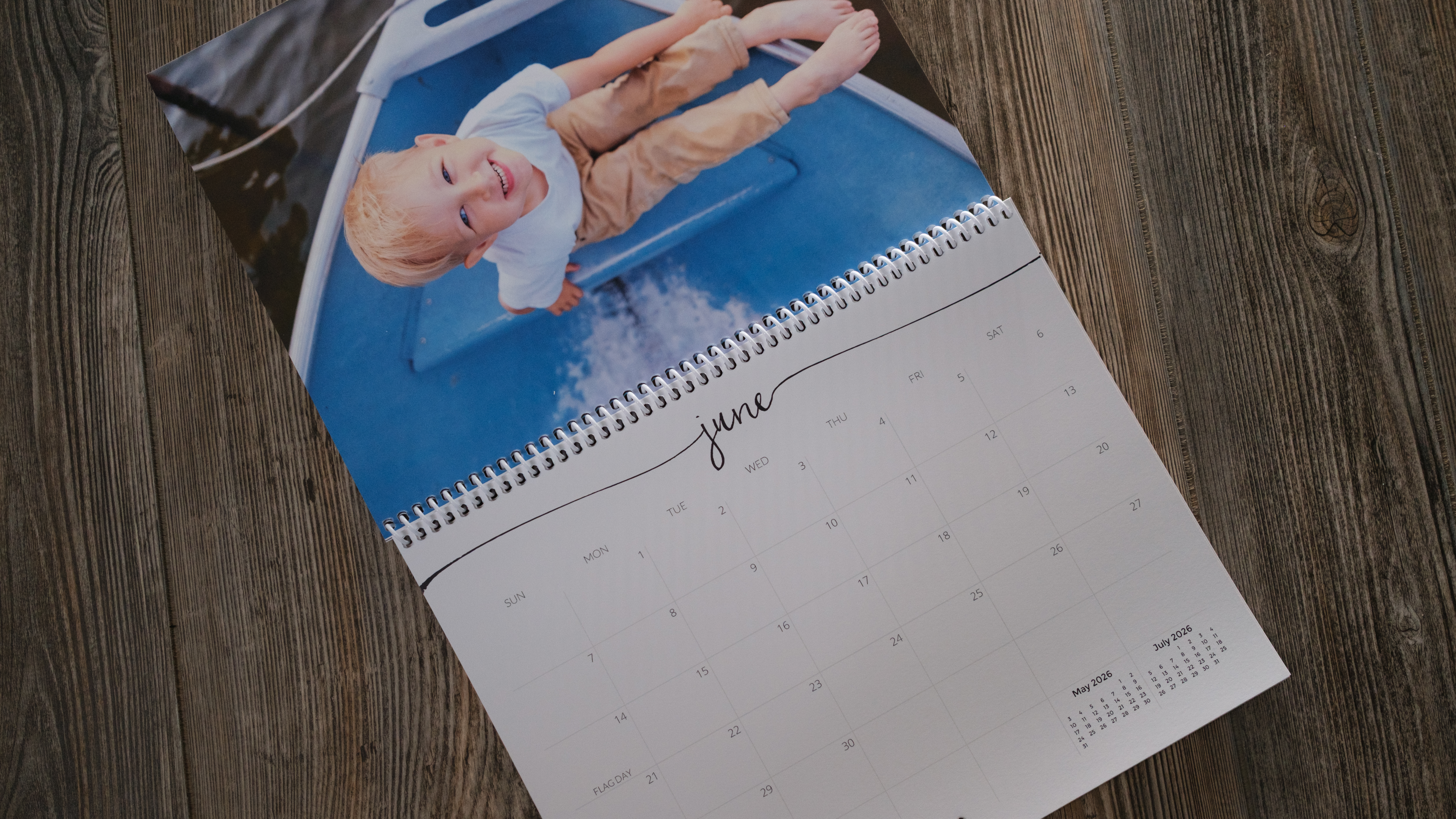 A photo calendar from Nations Photo Lab on a wood background