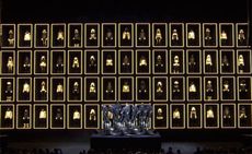 still from Moncler Grenoble's operatic show featuring 60 models in towering cubbyholes, and nine opera singers strapped into what appeared to be bionic stretchers in the foreground