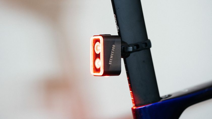 A close up of a rear bike light with two bulbs and one bulb underneath