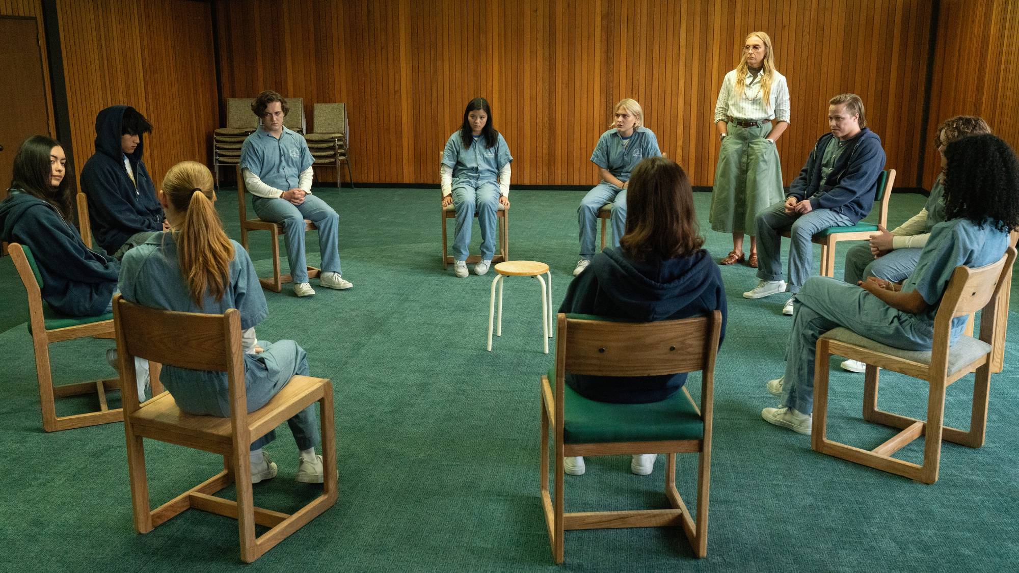 A scene from Netflix&#039;s &amp;quot;Wayward&amp;quot; showing a group therapy session at Tall Pines Academy