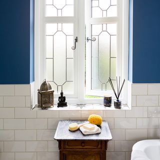 bathroom with window and wooden table