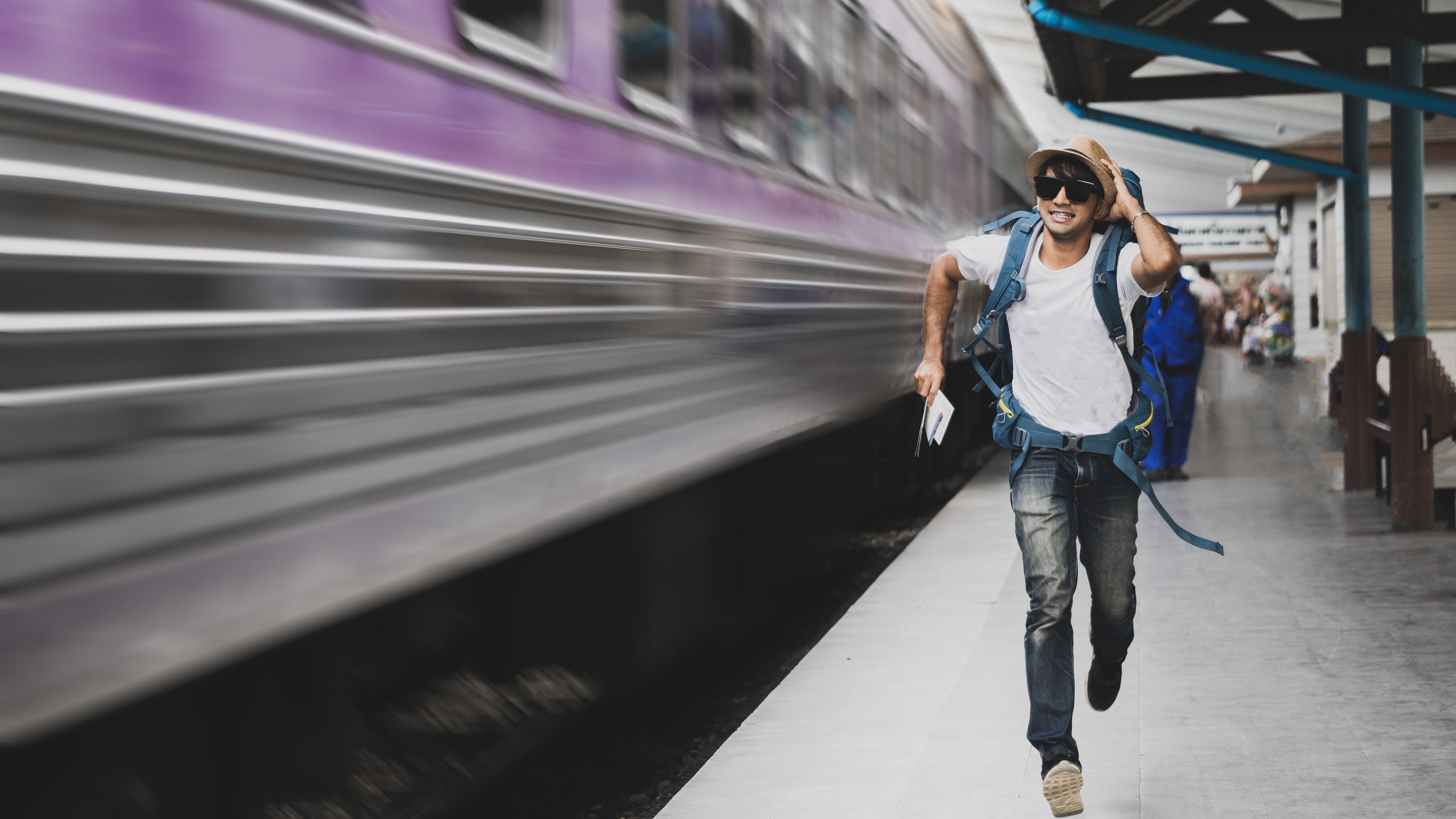Tourist running after a train
