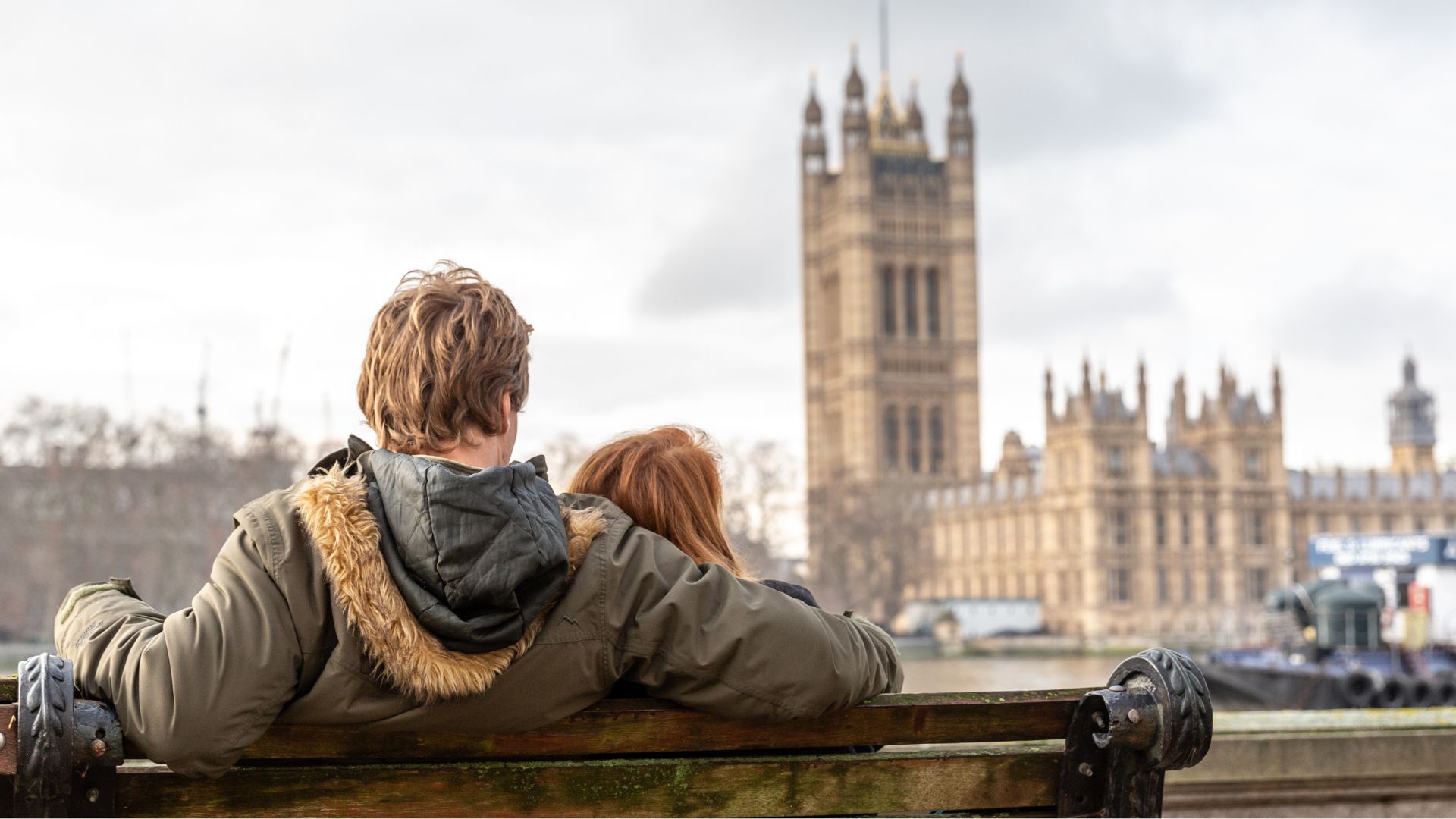 A couple is seen by the Thames River