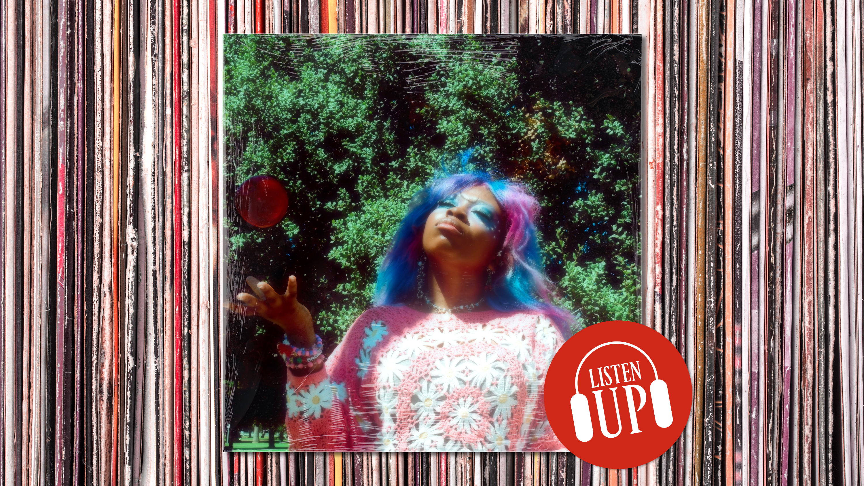 an image of hemlocke springs throwing up an apple against a backdrop of a vinyl record stack