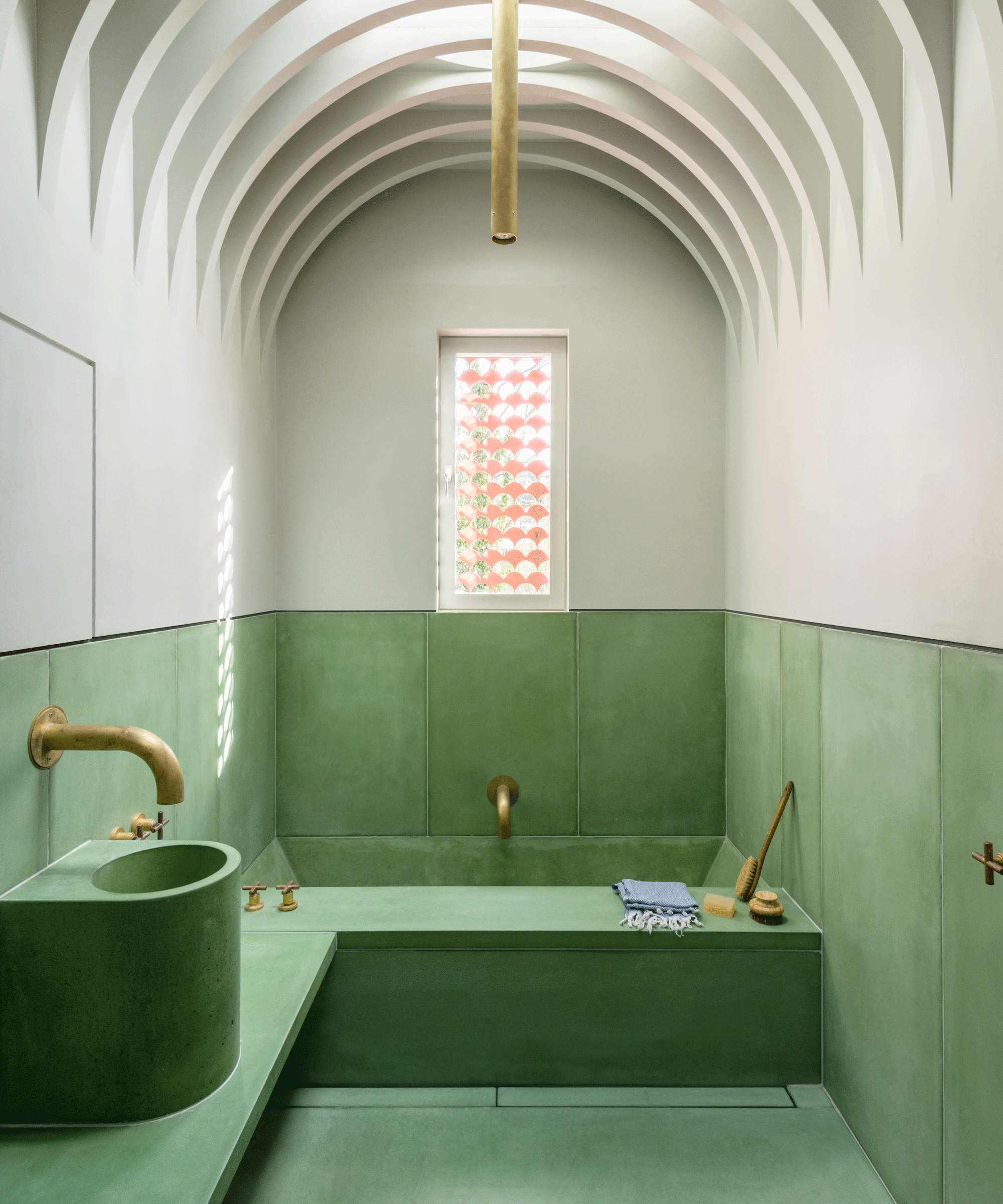 Bathroom with green concrete on the bottom half and pale on the top