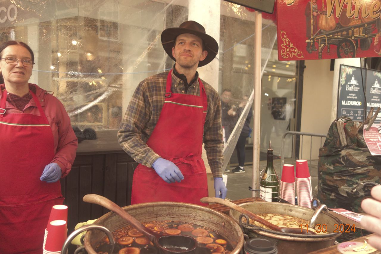 Mulled wine vendor in the city of Bath, UK, with retro photo picture effect