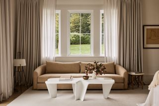 beige living room with white coffee table and beige bench seat sofa