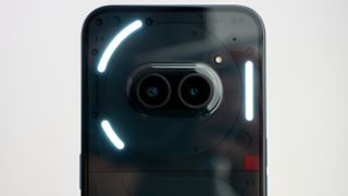 The camera island on the back of the Nothing Phone (2a) with the glyph lights illuminated