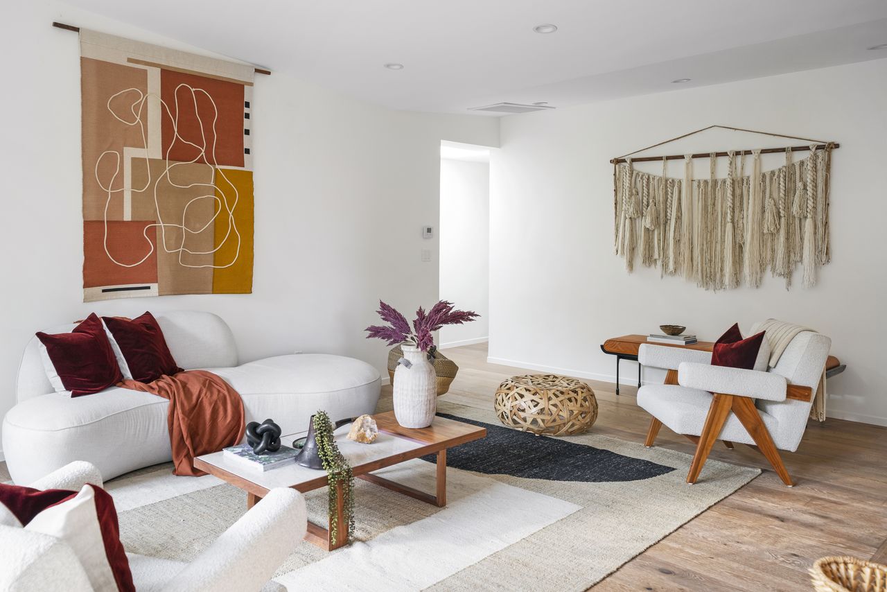 A bohemian style living room with a macramé wall hanging