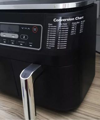 Air fryer conversion chart on the side of an air fryer