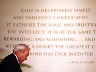 arnold palmer in front of a quote of his on a screen behind