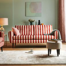 Sofa.com's Jack 3 Seater Sofa and Armchair in striped velvet in a mint green-painted living room with a beige rug