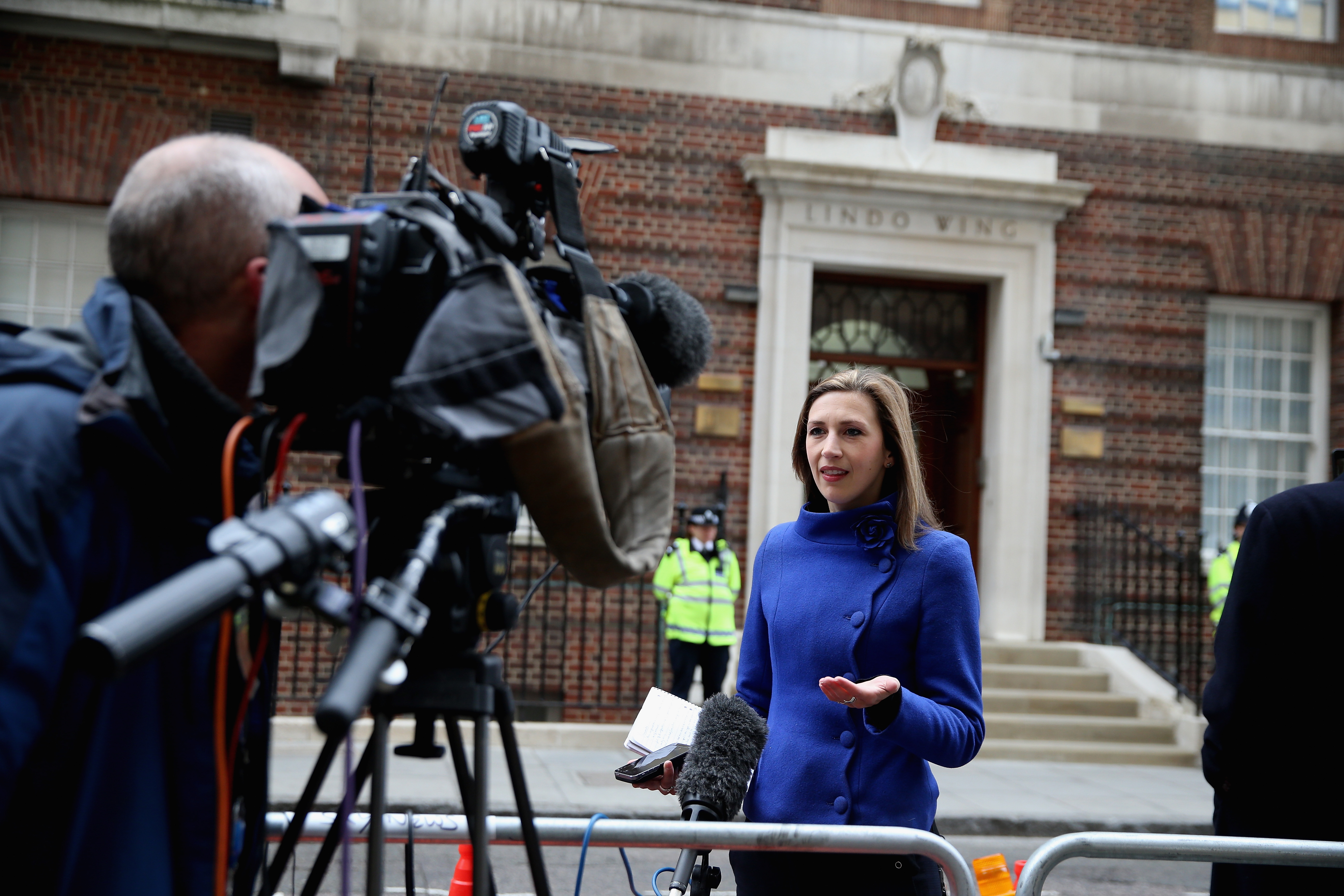 Rhiannon Mills wearing a blue coat reporting outside the Lindo Wing