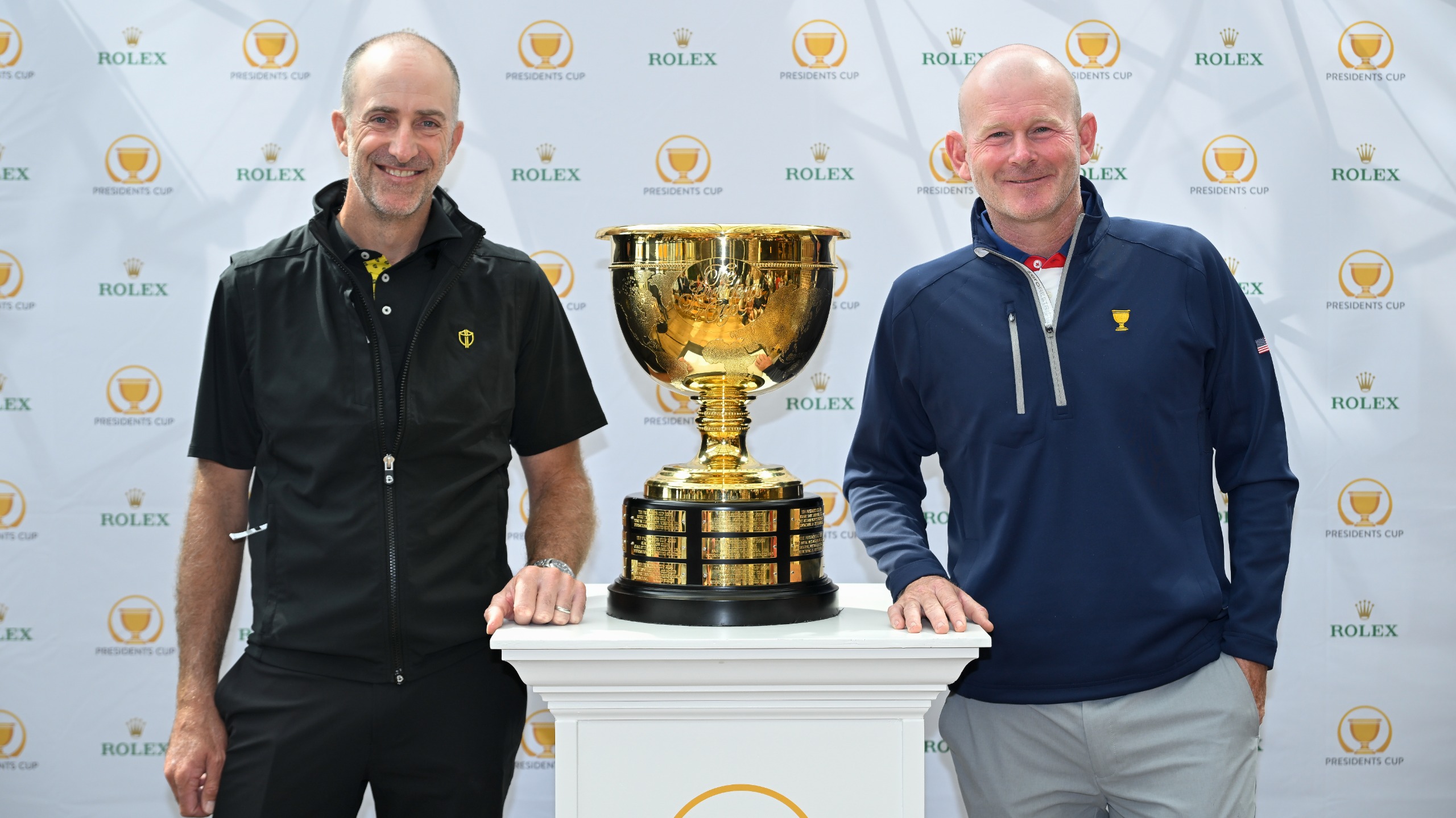Geoff Ogilvy and Brandt Snedeker stand with the Presidents Cup trophy.