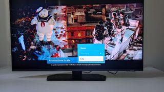 The Samsung QN90C displaying Ghostbusters with a menu screen visible at the bototm.