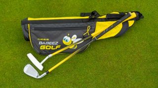 Inesis Kid's Golf Kit 2-4 Years resting on the green showing off its cool yellow colorway