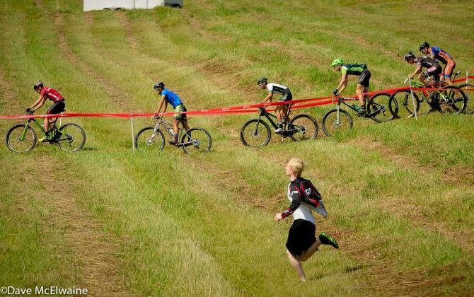 A fan tries to keep pace with the riders
