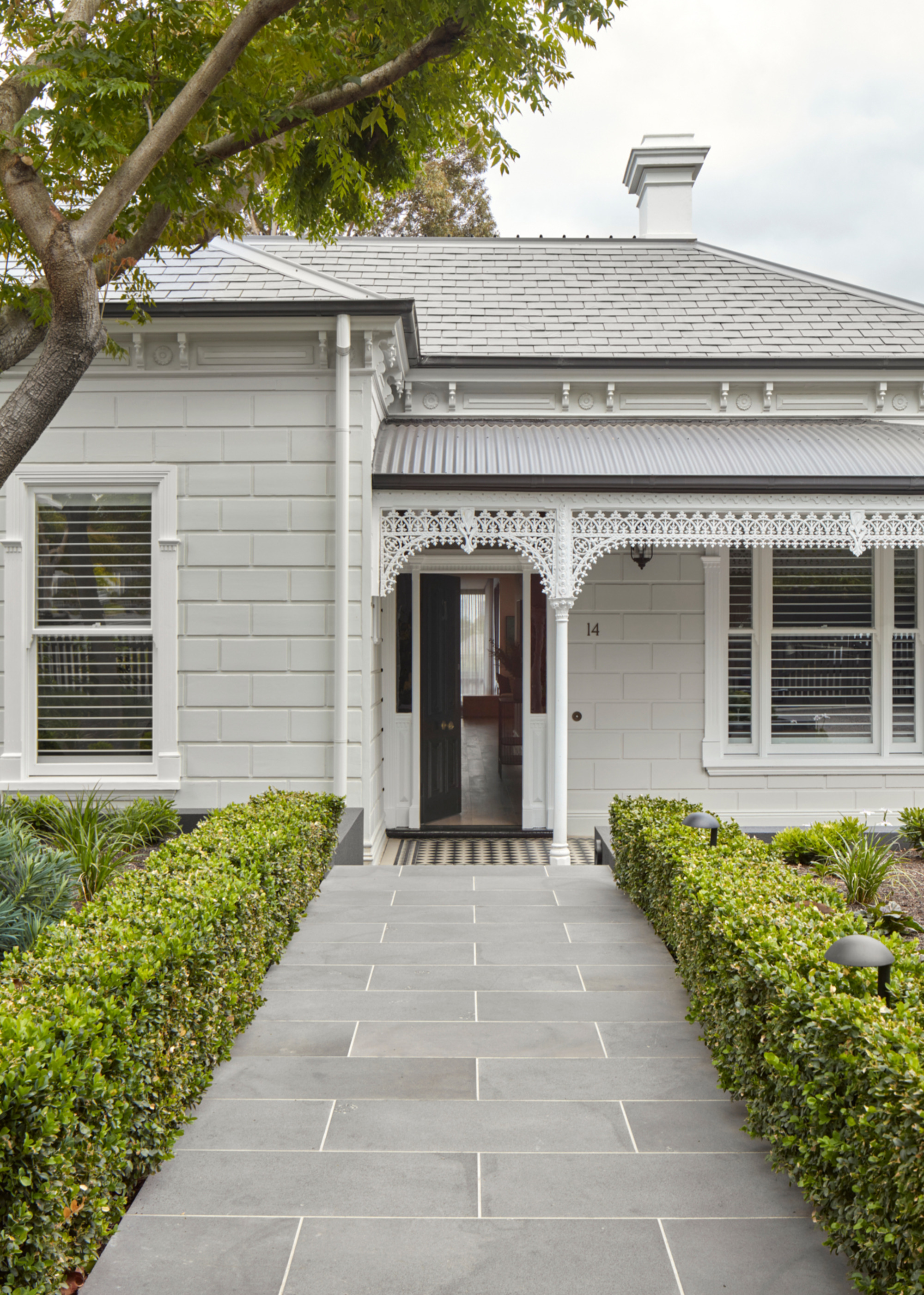 White painted exterior of Victorian home
