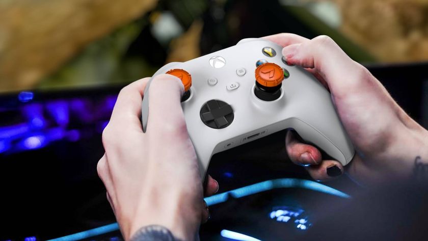 Official product image showing orange thumbsticks sitting on a wireless white Xbox controller.