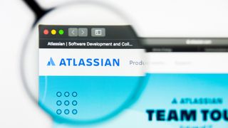 The Atlassian logo on the website seen through a magnifying glass