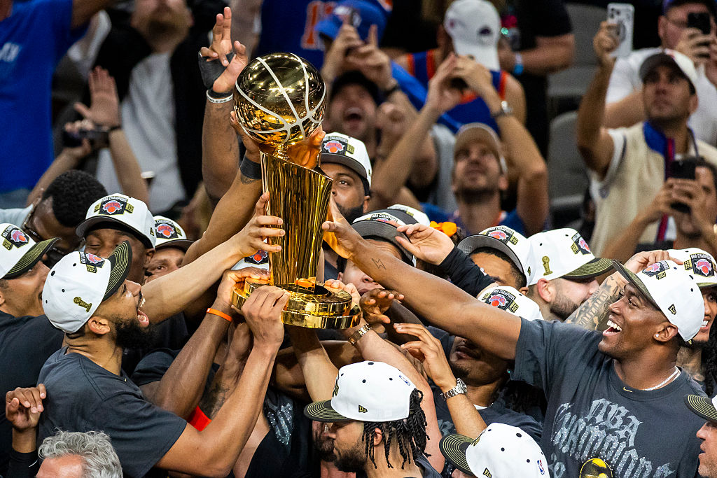 SAN ANTONIO, TEXAS - JUNE 13: New York Knicks players celebrate while receiving the Larry O&amp;apos;Brien Championship Trophy after defeating the San Antonio Spurs 94-90 in Game 5 of the NBA Finals at Frost Bank Center in San Antonio on Saturday, June 13, 2026. (Katina Zentz/San Antonio Express-News via Getty Images)
