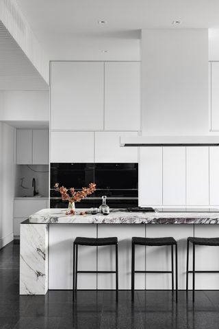 An all-white kitchen with uncluttered countertop